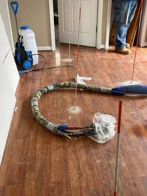 Polyurethane foam being injected to fill voids beneath a slab