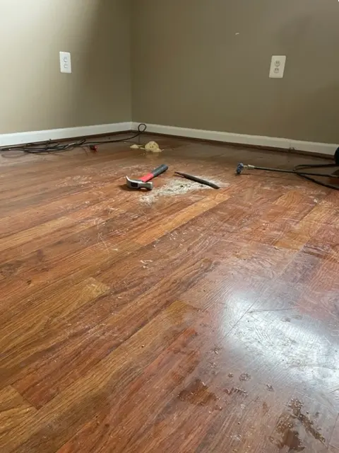 Void filling in progress beneath a settled concrete slab
