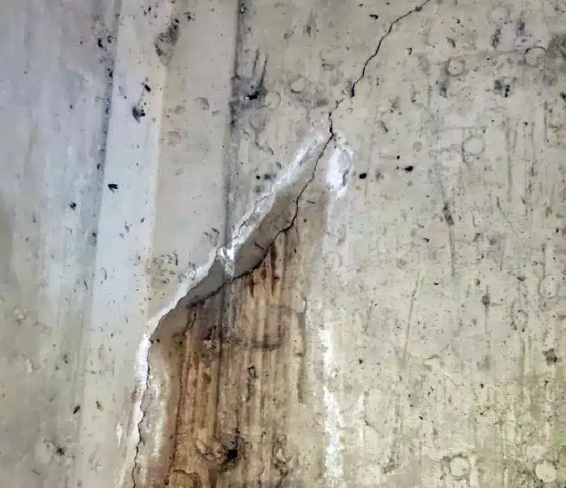 Foundation wall crack with efflorescence staining in a Southeast Michigan commercial basement