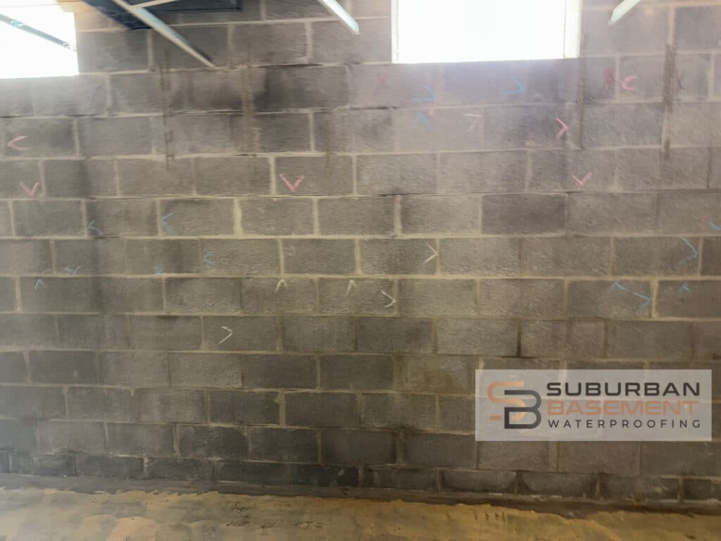 Water stained basement walls showing conditions before interior drain tile system installation in Southeastern Michigan