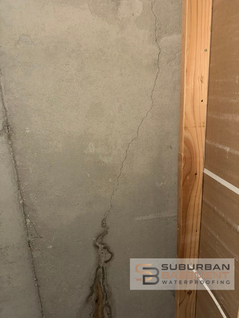 Leaking diagonal foundation crack in poured concrete basement wall — SE Michigan