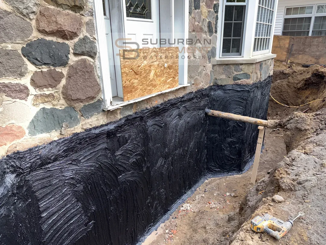 Exterior foundation waterproofing membrane applied to a basement wall in Southeastern Michigan