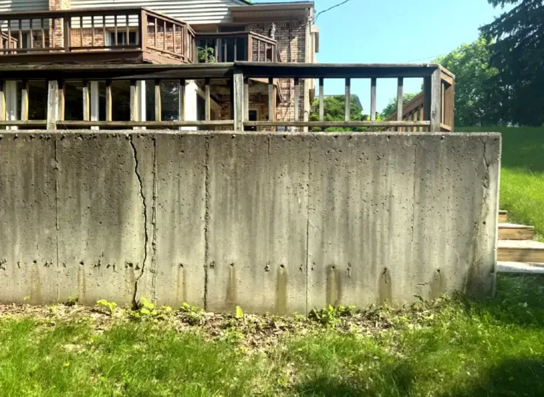 Poured concrete retaining wall showing structural movement
