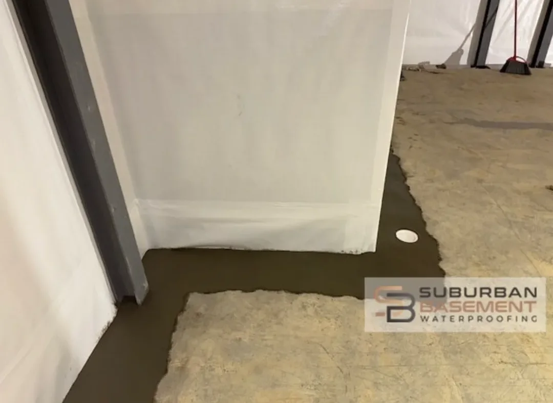 Interior basement drain tile system installed along a foundation wall in Southeastern Michigan