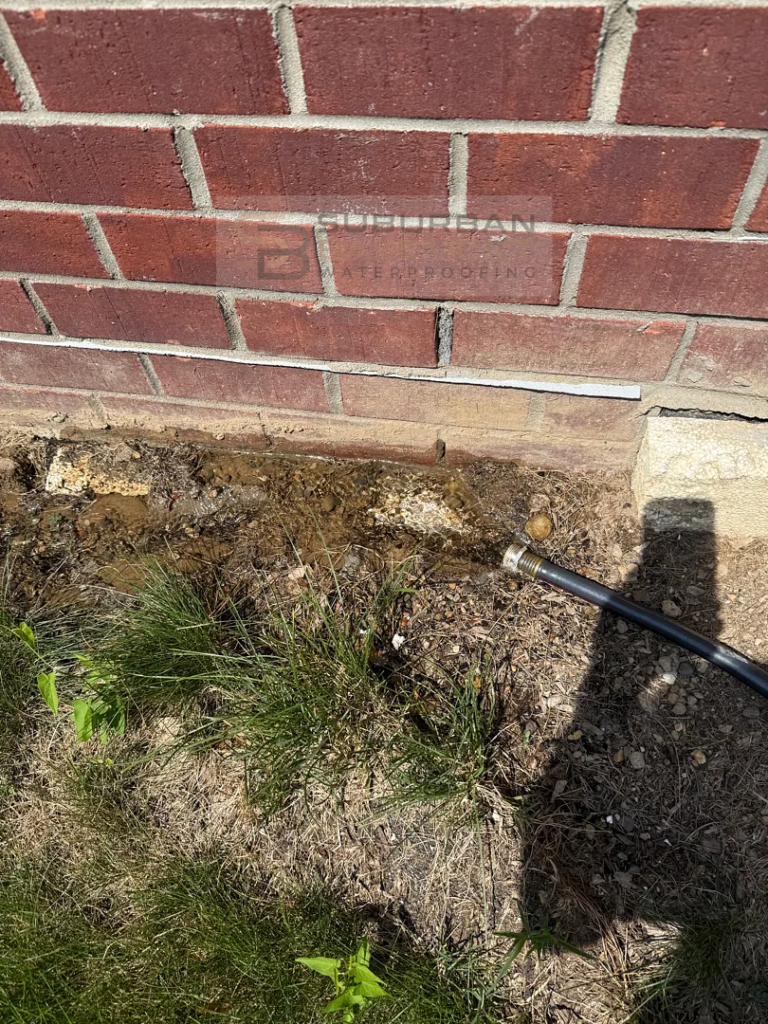 Water test verifying a high-pressure injection completely sealed a foundation crack in Shelby Township, Michigan