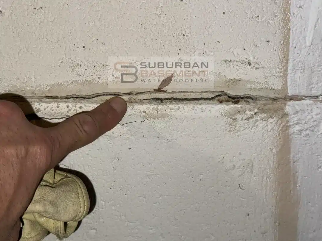 Bowing basement block wall with horizontal mortar joint crack in Ferndale MI before repair