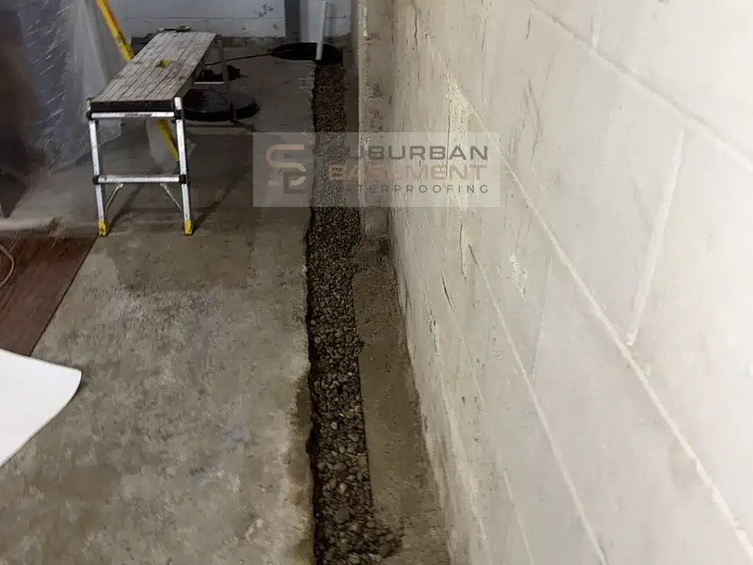 Drainage stone installed over new drain tile along a basement footing in Ferndale MI