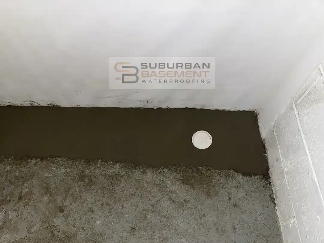 Finished basement perimeter with drain tile cleanout access in new concrete in Ferndale MI