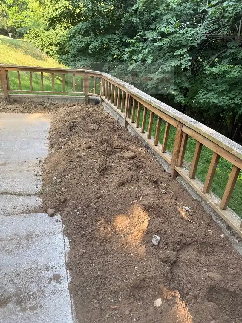 Straightened concrete retaining wall backfilled after anchor and drainage installation in Farmington Hills MI