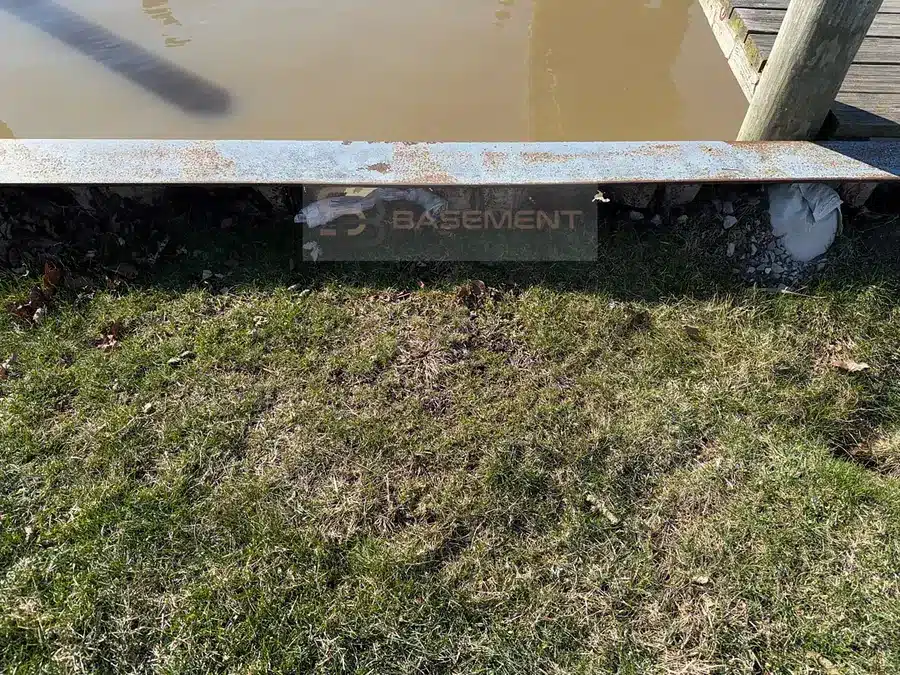Ground undercut beneath a canal seawall in Harrison Township MI before repair