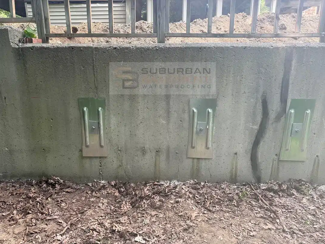 Wall anchor plates and tie rods installed on a concrete retaining wall in Farmington Hills MI
