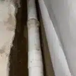 Drain tile dry fitted along a basement footing before drainage stone is installed