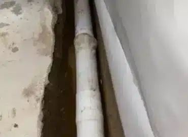 Drain tile dry fitted along a basement footing before drainage stone is installed